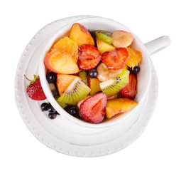 Fresh fruits salad in bowl isolated on white