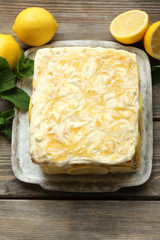 Tasty lemon cake on table at home