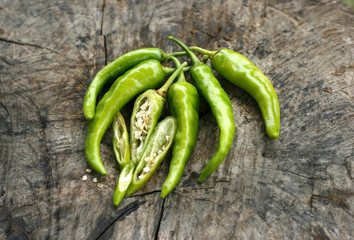 green hot peppers on a wood
