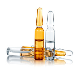 transparent and yellow medical ampoules on an isolated white bac - obrazy, fototapety, plakaty