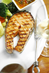 close up salmon steak in white dish