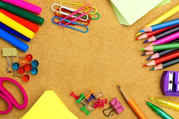 Colorful school supplies frame on a bulletin board