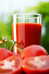 Tomatoes and juice in the garden. Organic food