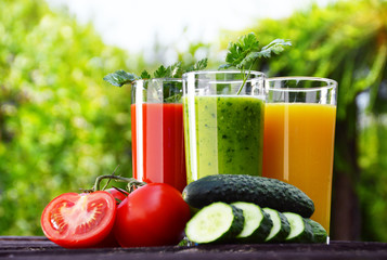 Glasses with fresh vegetable juices in the garden. Detox diet