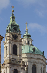 Fototapeta na wymiar Belltower and temple dome. St. Mikulash's cathedral, Prague