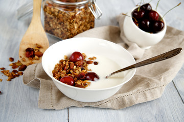 Granola with yogurt and cherries in a bowl