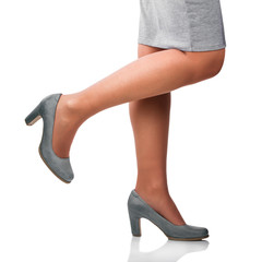 Young woman wearing gray shoes.