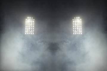 Stadium lights against dark night sky backgroundon