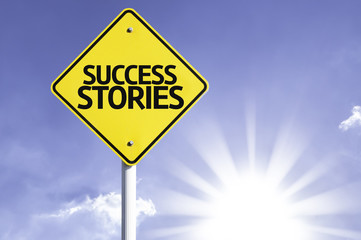 Success Stories road sign with sun background