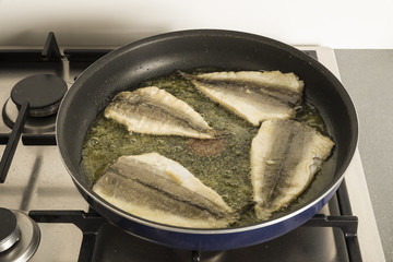 Fish frying in a pan