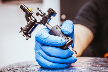 Tattooist makes a tattoo. Closeup