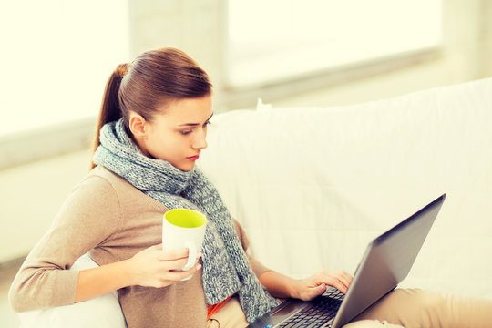 Diseased Woman In Scarf Using Laptop At Home