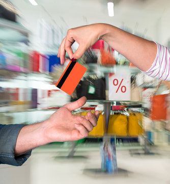 Woman giving credit card to man