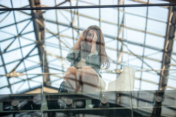 young woman looking through window at airport