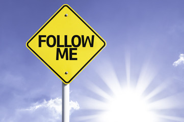Follow Me road sign with sun background