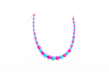 Close up with a colorful necklace isolated blue pink jewelry