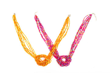 Close up with a colorful necklace isolated yellow pink jewelry