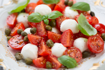 Close-up of caprese salad with capers, horizontal shot