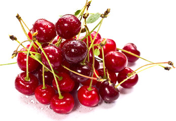 A pile of ripe cherries on white background