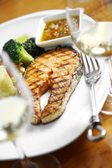 close up salmon steak in white dish