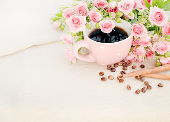 Cup of black coffee and red rose.