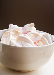 Marshmallows in white bowl close up