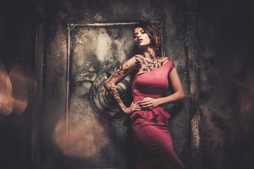 Tattooed beautiful woman in old spooky interior