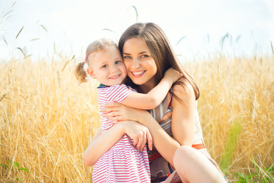 Pretty young mother with daughter are happy in sunny day