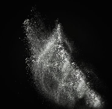 White Powder Exploding Isolated On Black