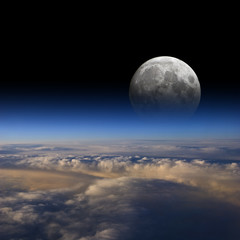 The Moon rises over planet Earth.