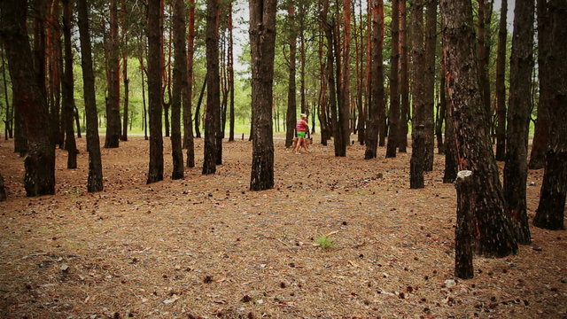 Woman with dog in pine fores