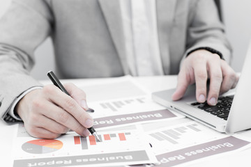 Businessman analyzing investment charts with laptop. Accounting