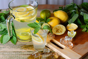 Lemonade with mint and lemon on the table.