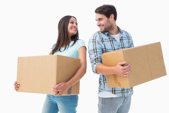 Happy young couple with moving boxes