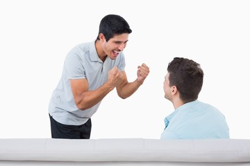 Fototapeta premium Happy football fans cheering on couch