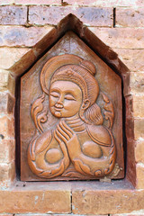 Woman carving on wall of resort at  Chiangmai, Thailand.