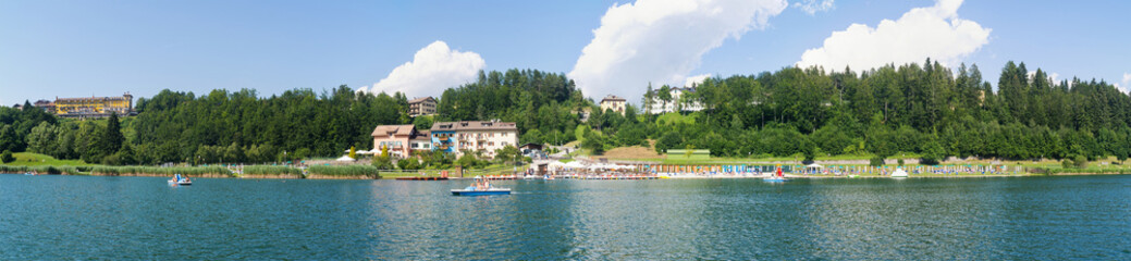 Tourists enjoying Lavarone Lake. Italy.