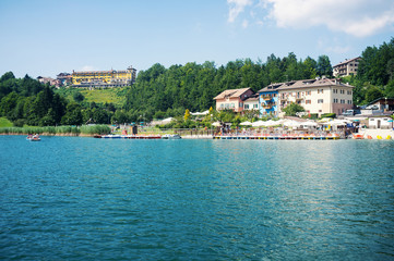 Fototapeta na wymiar Tourists enjoying Lavarone Lake. Italy.