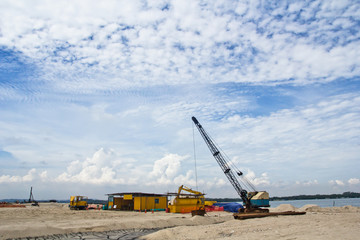 Fototapeta na wymiar Construction site with crane and building on blue sky