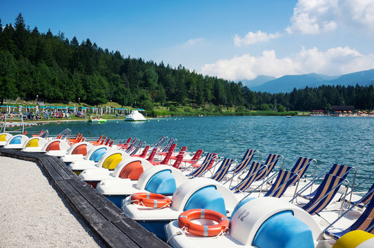 Paddle boats in Lavarone Lake. Italy.