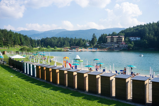 Tourists enjoying Lavarone Lake. Italy.