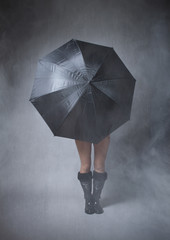 anonymous girl covering with black umbrella