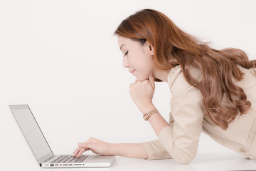 Fototapeta premium Portrait of a young business woman using laptop at office