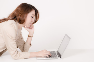 Portrait of a young business woman using laptop at office