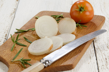 sliced onion on old wooden board