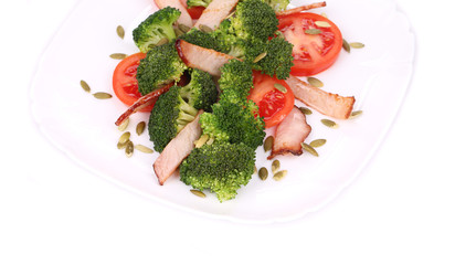 Broccoli salad with pumpkin seeds and tomatoes.