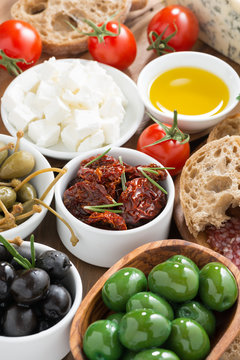 assorted Italian antipasti - olives, pickles and bread, top view