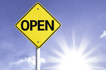 Open road sign with sun background