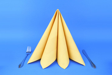 Folded napkin on the blue background