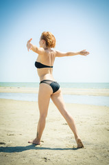 Fototapeta na wymiar Beautiful woman on a beach